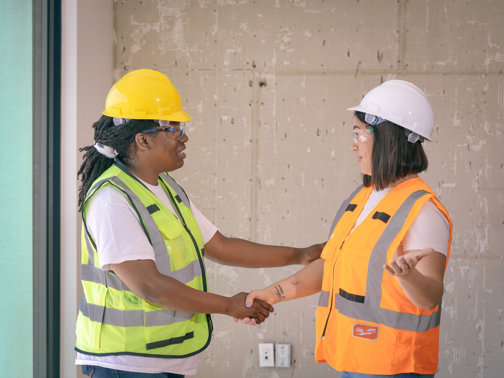 A handshake between two people at a construction site