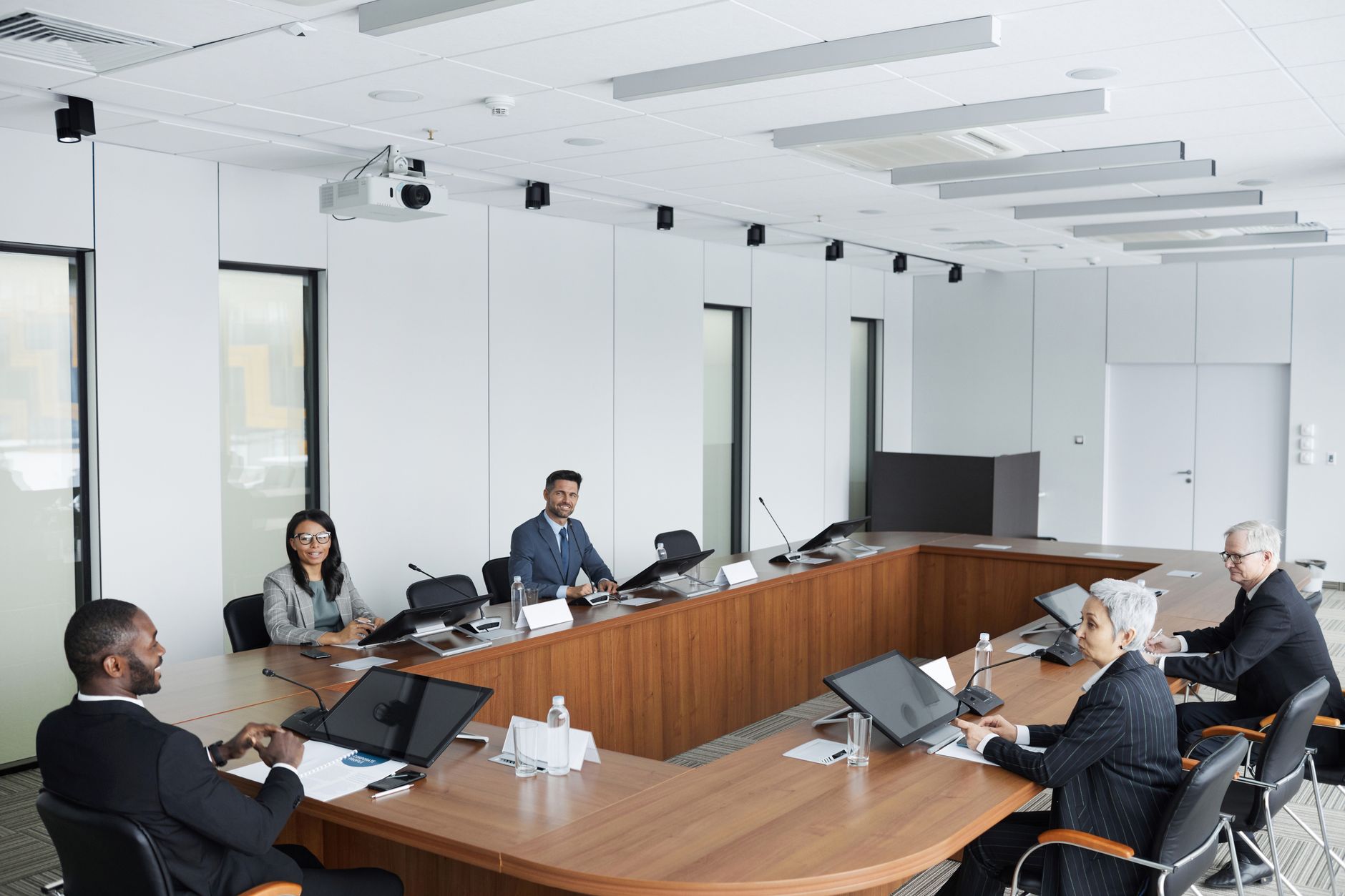 A group of professionals seated around a boardroom table