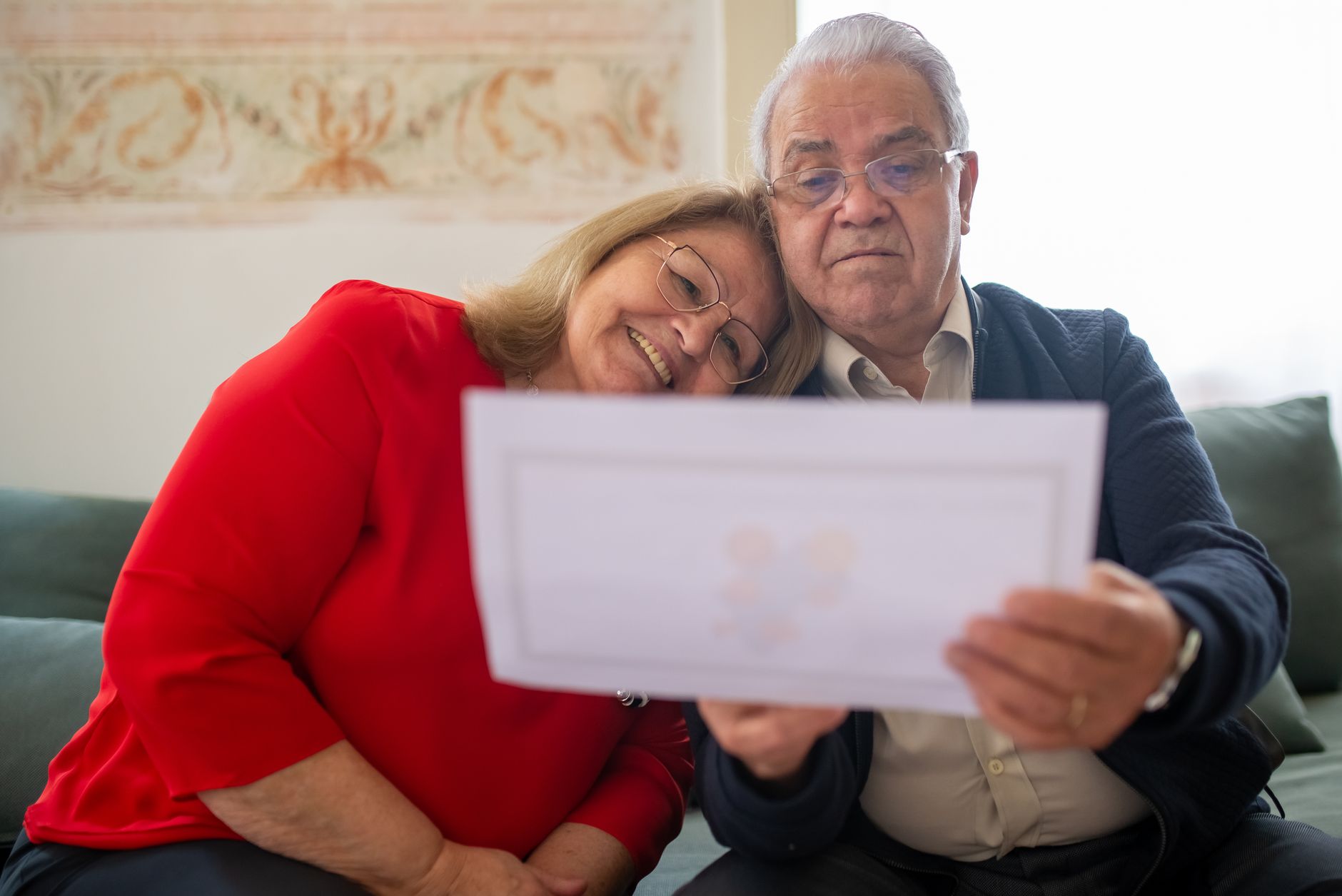 A senior couple reviewing documents together at home