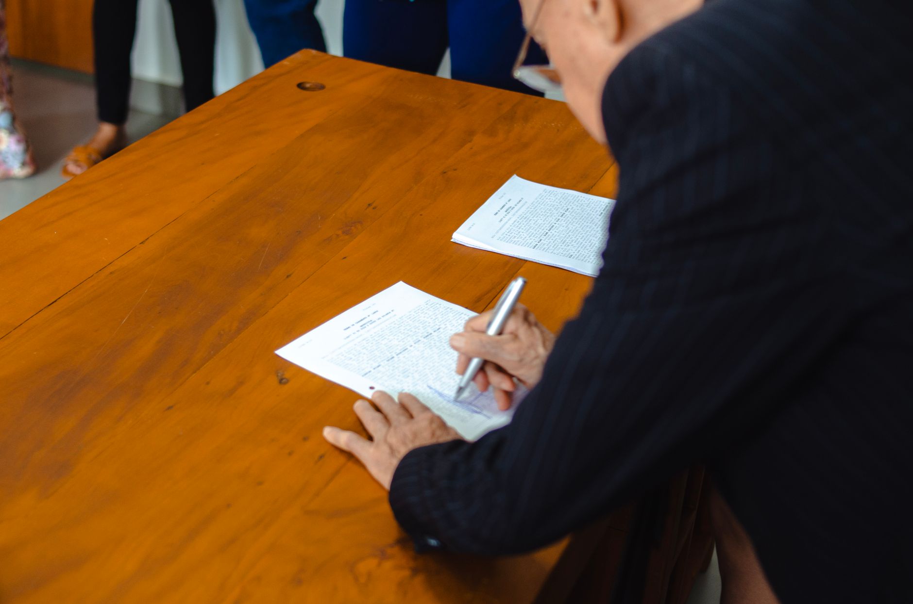 Several family members gathered around a table with documents