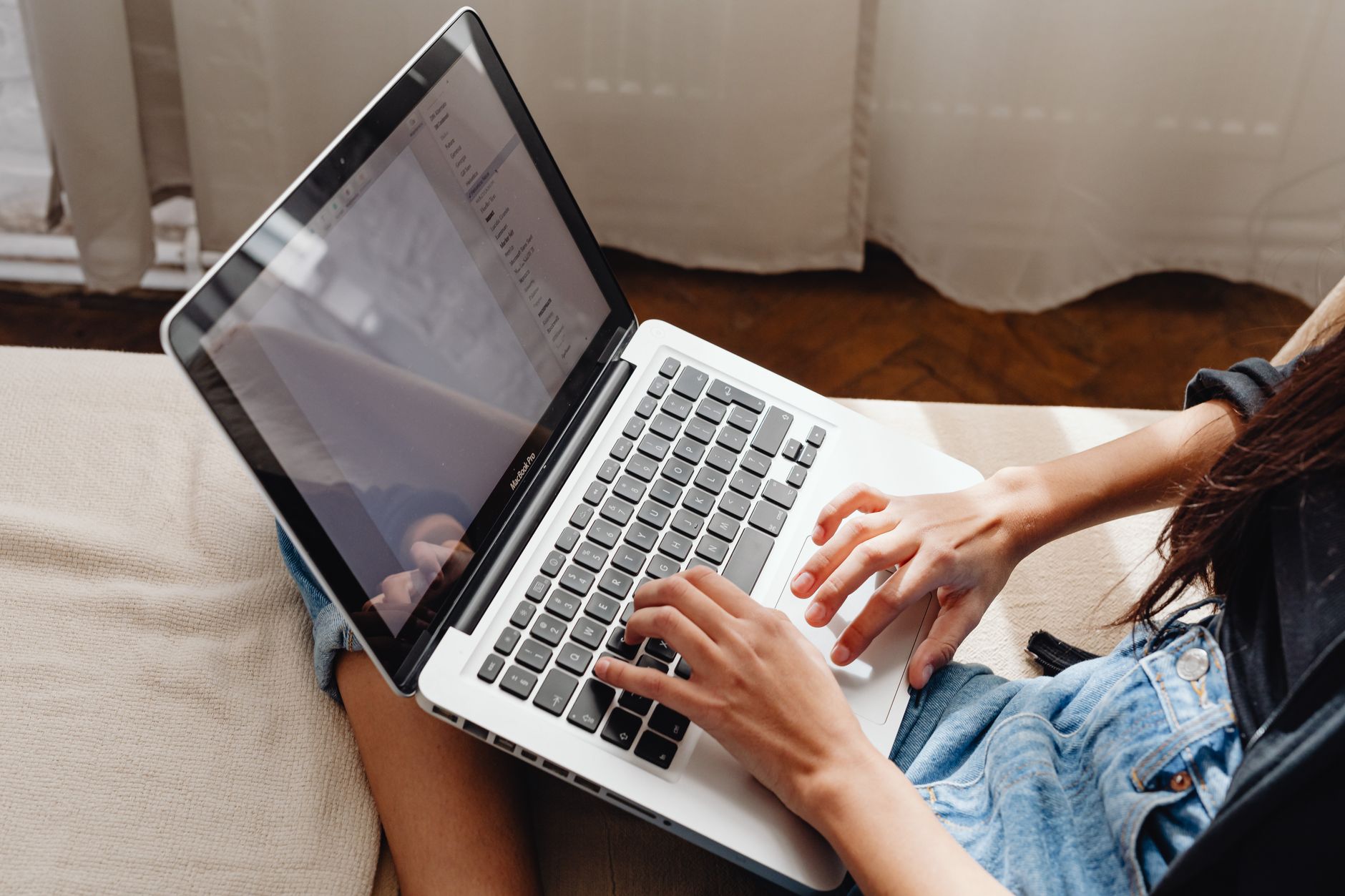 A person researching on a laptop at home
