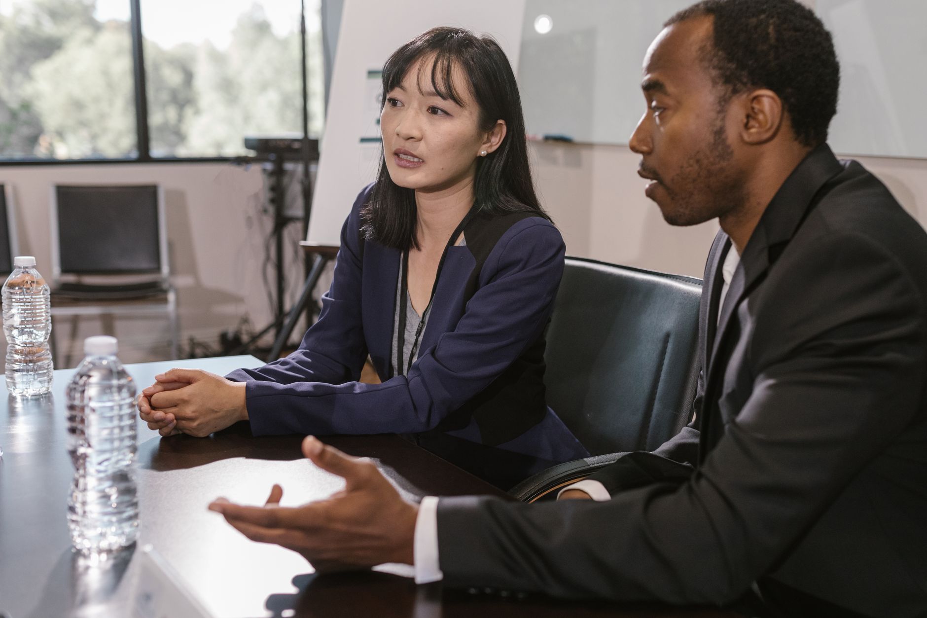 Two people in conversation across a meeting table