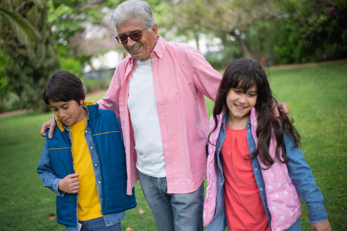 A grandfather spending time outdoors with his grandchildren