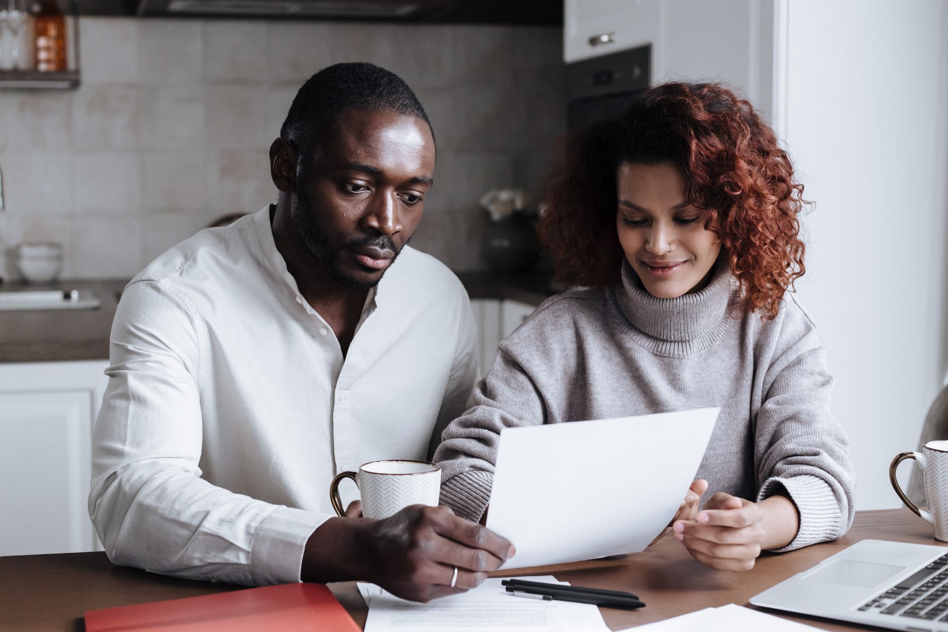 A couple reviewing paperwork together at a table