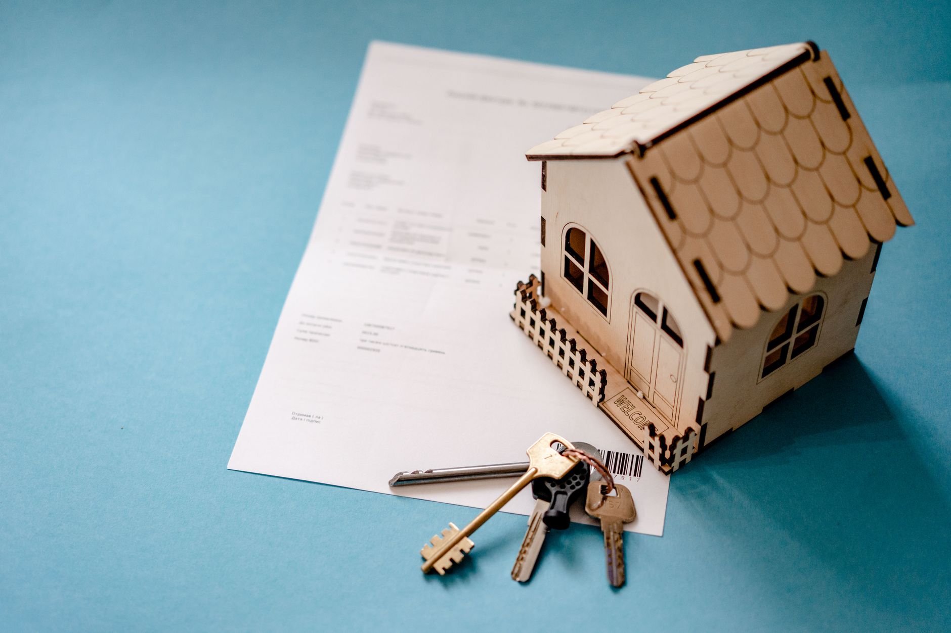 A small house model resting on top of property paperwork