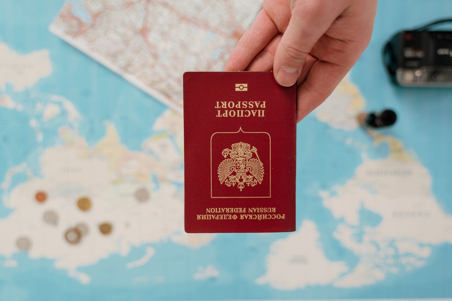 A passport and travel documents resting on a world map
