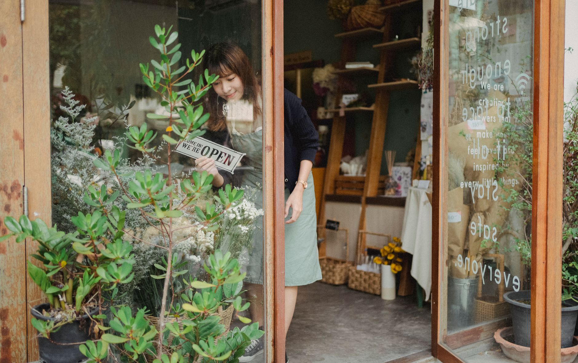 A small business owner reviewing paperwork near a storefront counter