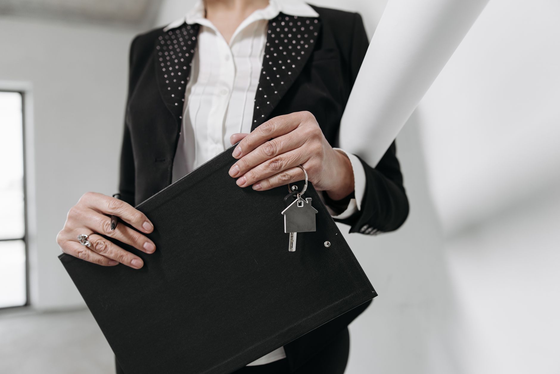 A real estate professional handing over a set of house keys